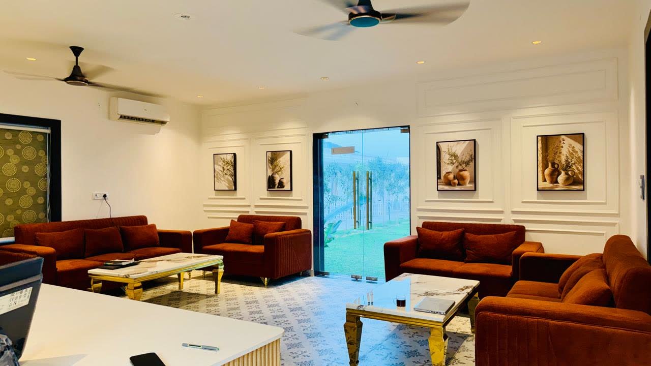 Indoor lounge with velvet sofas opening to the garden