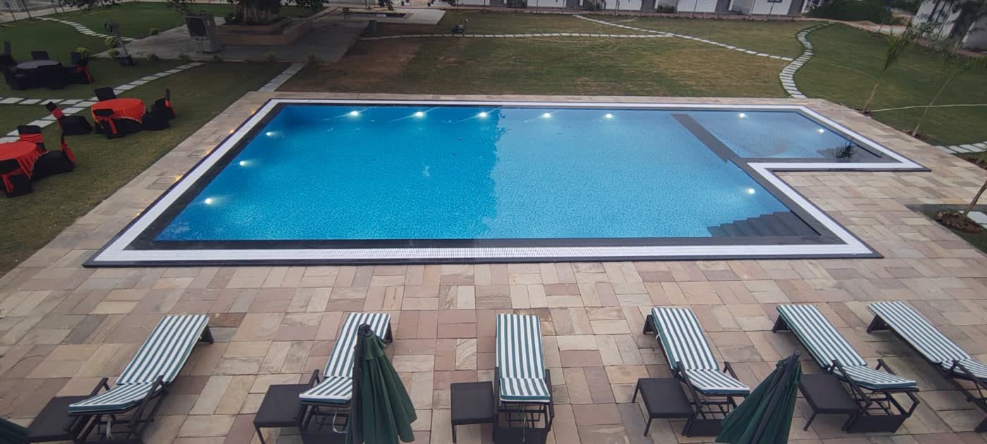 Pool and open lawn seating in daylight